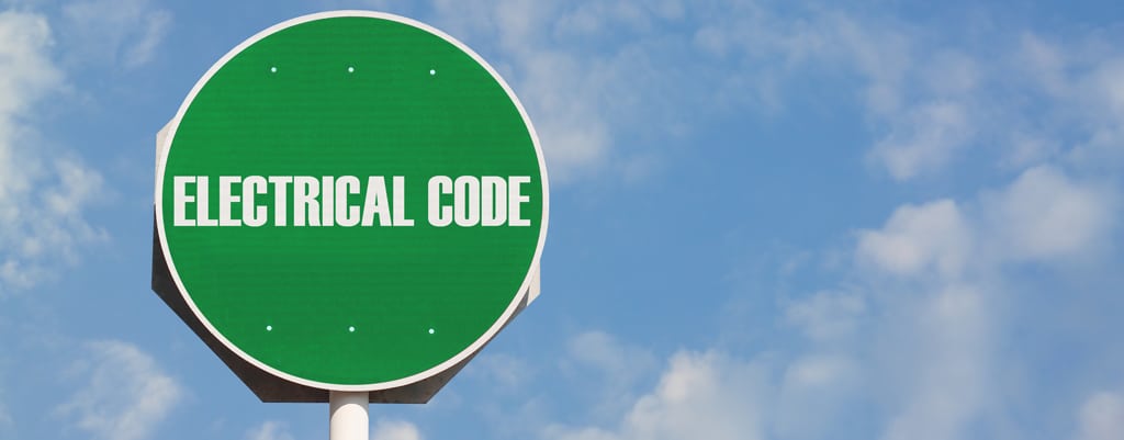 Green sign with "Electrical Code" on it against a blue sky background