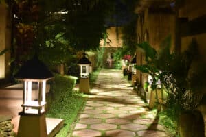 Footpath amidst houses at night, Outdoor Lighting Safety.