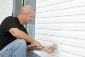 Checking out electrical outlets on the outside of a residential home., Outdoor Electrical Safety.